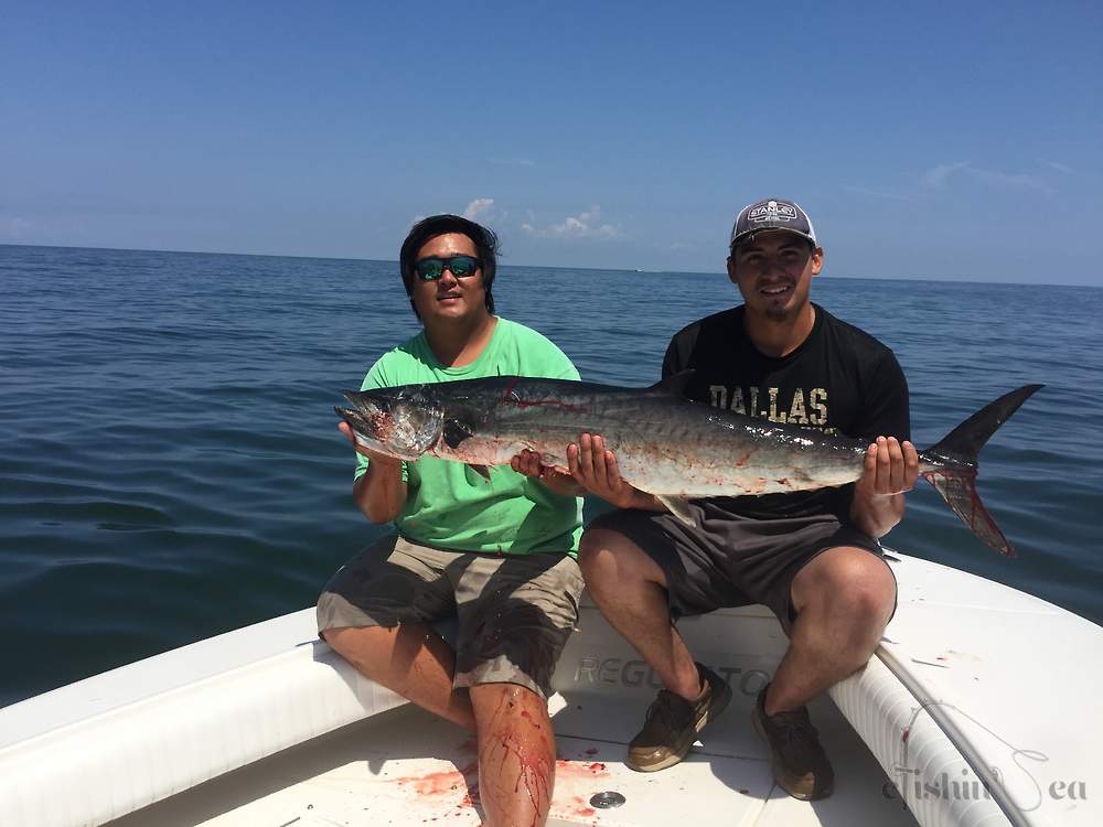 Pictured here is one of our first mates Andrew on left holding 2018 King Mackerel with customer